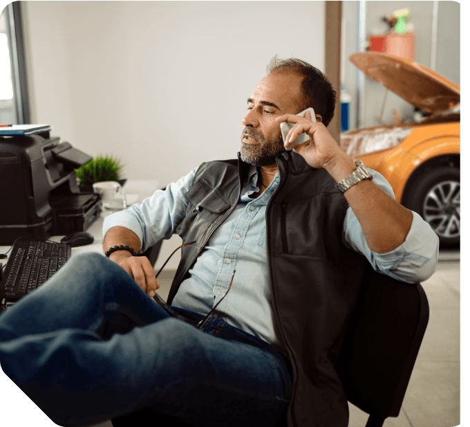 Professional person on phone in auto repair setting